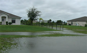 A home with minor flood damage and the water level is half way up the lawn